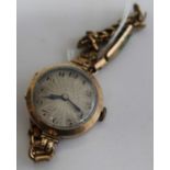 A ladies 9ct gold cased wrist watch having unsigned engine turned dial, manual wind movement and