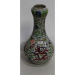 A Chinese export vase of onion shape, enamel decorated with a five clawed dragon amidst foliage,