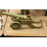 A brass model of an artillery cannon on wooden plinth, 45cm