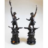 A pair of early 20th century French spelter figures, in the form of females standing upon an eagle