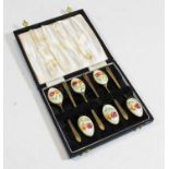 A set of six gilt metal spoons, each having flroal enamelled bowls, the interior bowl with a