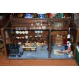 An early 20th century dolls house diorama in the form of two rooms with various furnishings and