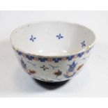 An 18th century English Delft bowl, decorated in shades of blue, brown and green, on circular foot