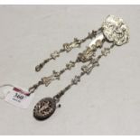 A Victorian silver chatelaine, the hook relief decorated with a reclining figure supporting three