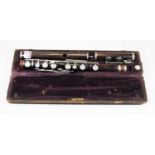 A 20th century rosewood flute cased, the flute stamped and case bearing label for 'Douglas & Co 7