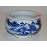 A Chinese blue and white bowl of squat circular form, decorated with mountain scenes 15cm dia.