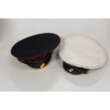 A naval style peaked cap together with one other (2)