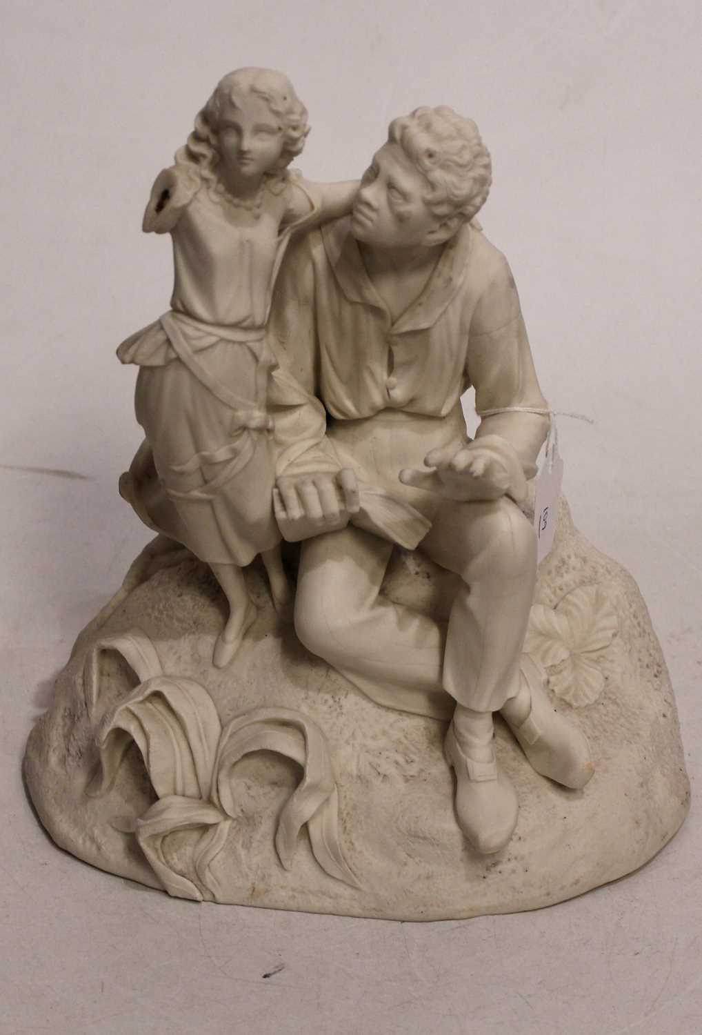 A Parian figure of a seated gentleman, with book in hand and child at his shoulder, on