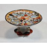 A Japanese late Meiji period miniature tazza, the circular bowl decorated with various figures among