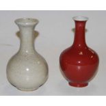 A Chinese sang-de-bouef bottle vase h15cm, together with another similar crackle glazed vase (2)