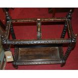 An early 20th century relief carved oak bobbin turned twin division stick-stand, w.58.5cm