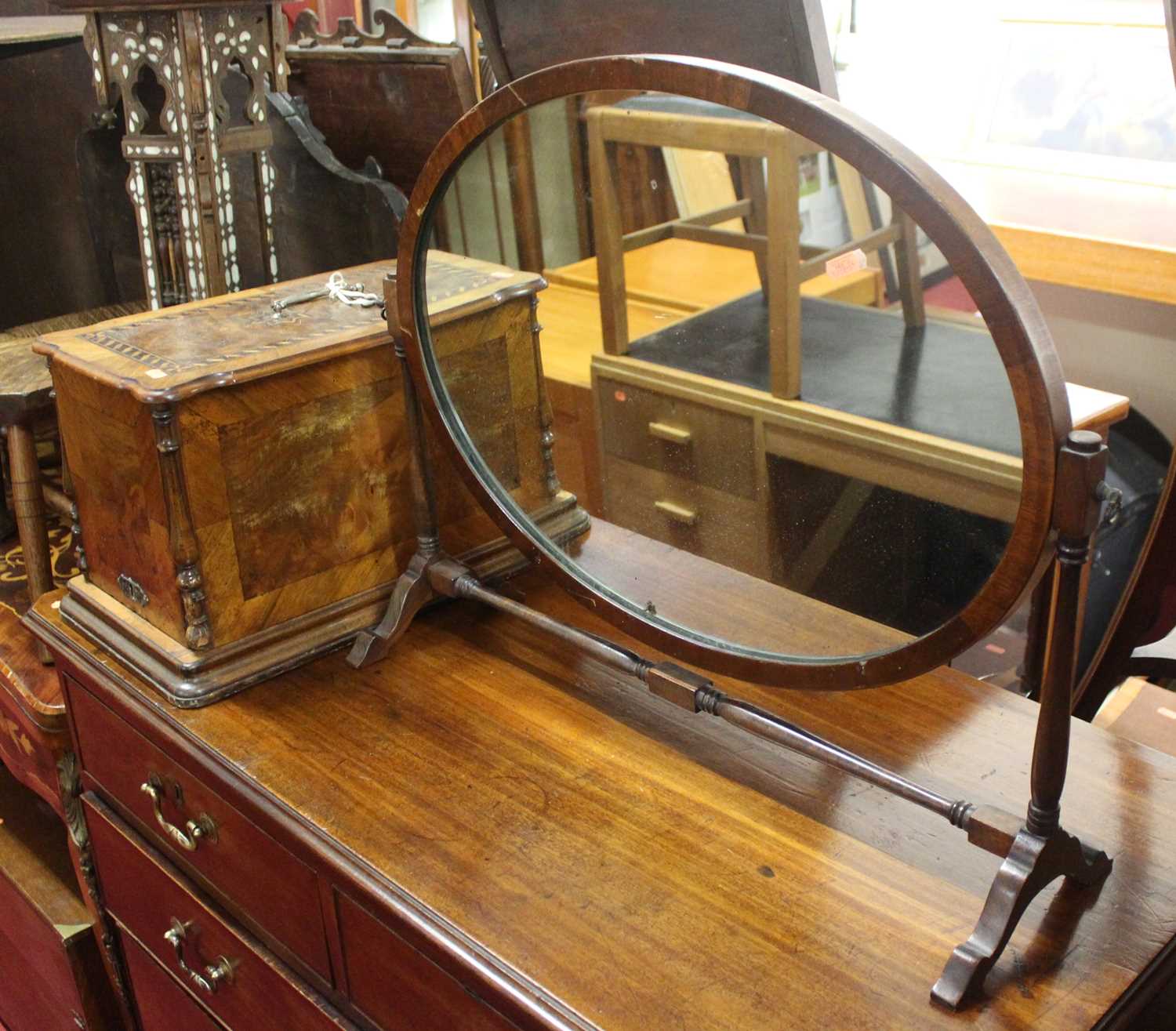 A walnut cased sewing machine, together with a mahogany swing framed toilet mirror (2)