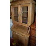 A pine dresser, with twin glazed upper doors, w.92cm