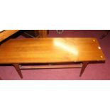 A 1970s teak long low coffee table with laddered undertier, length 122cm