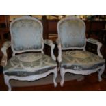 A pair of Louis XV style white painted and needlework silk upholstered fauteuils, each raised on