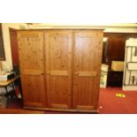 A modern pine three door wardrobe, w.193cm