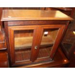 An early 20th century oak small table top double door glazed display cabinet, width 57cm
