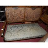 A 1930's caned beech two seater settee