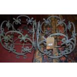 A pair of wrought metal floral design planter frames, width 31cm