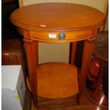 A contemporary cherrywood oval two-tier occasional table, with single frieze drawer, width 54cm