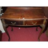 An early 20th century bowfront ledgeback two drawer side table raised on cabriole supports, width