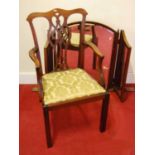 An Edwardian mahogany open arm chair having a fret carved vase shaped splat back above a drop-in