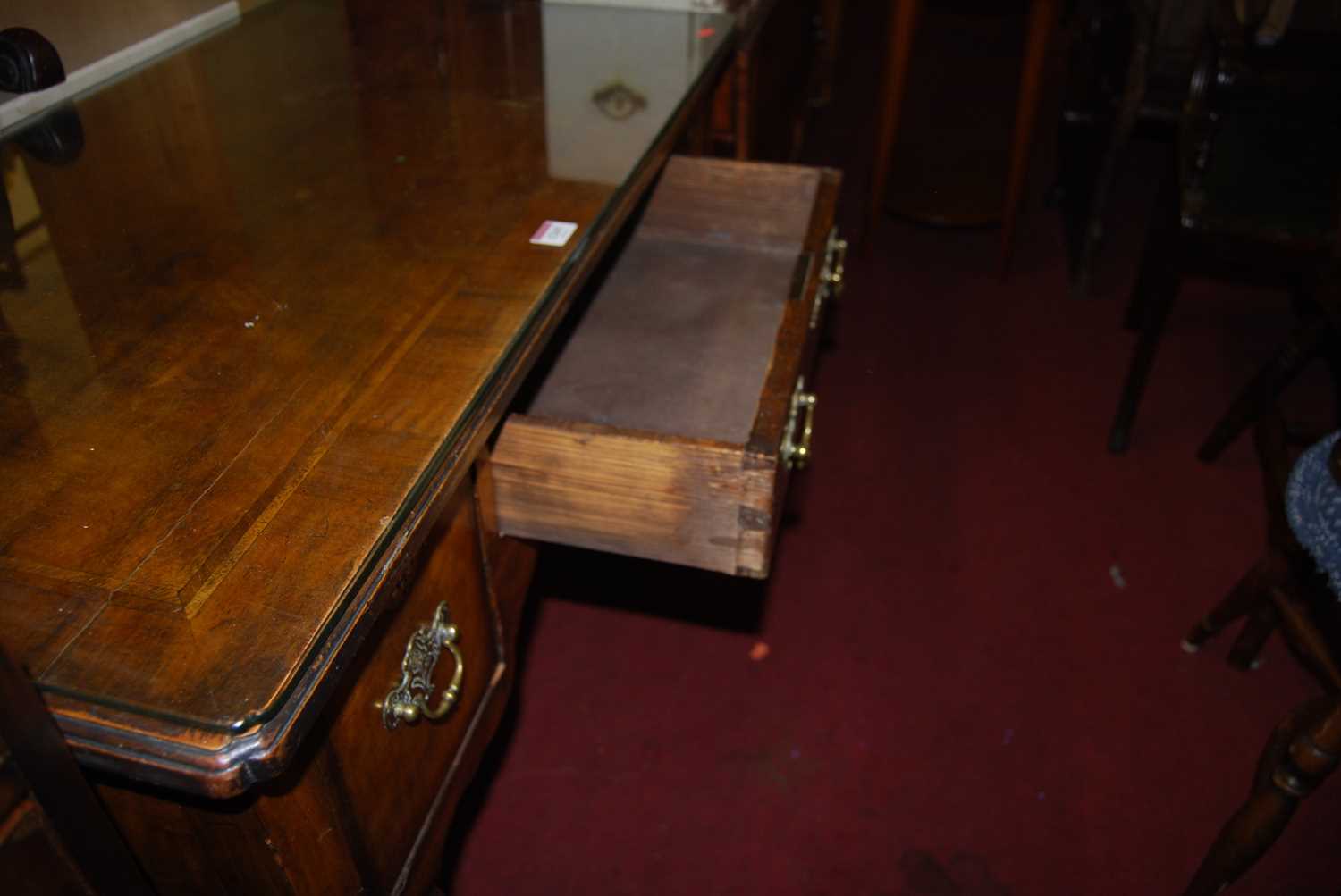 An early Georgian style figured walnut and feather banded three drawer kneehole lowboy, raised on - Image 4 of 5