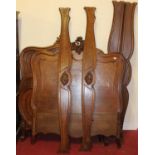 A near pair of 19th century French parquetry inlaid mahogany single bedsteads