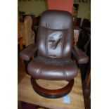 A Stressless brown leather upholstered swivel armchair and foot stool (2)Condition report: Overall