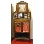 A late Victorian rosewood and satinwood inlaid corner cupboard enclosed by pair of mirrored doors,