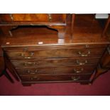 An early 19th century mahogany chest of four long graduated drawers, with upper brushing slide,