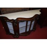 A Victorian figured walnut and white marble topped four door serpentine front credenza (the doors