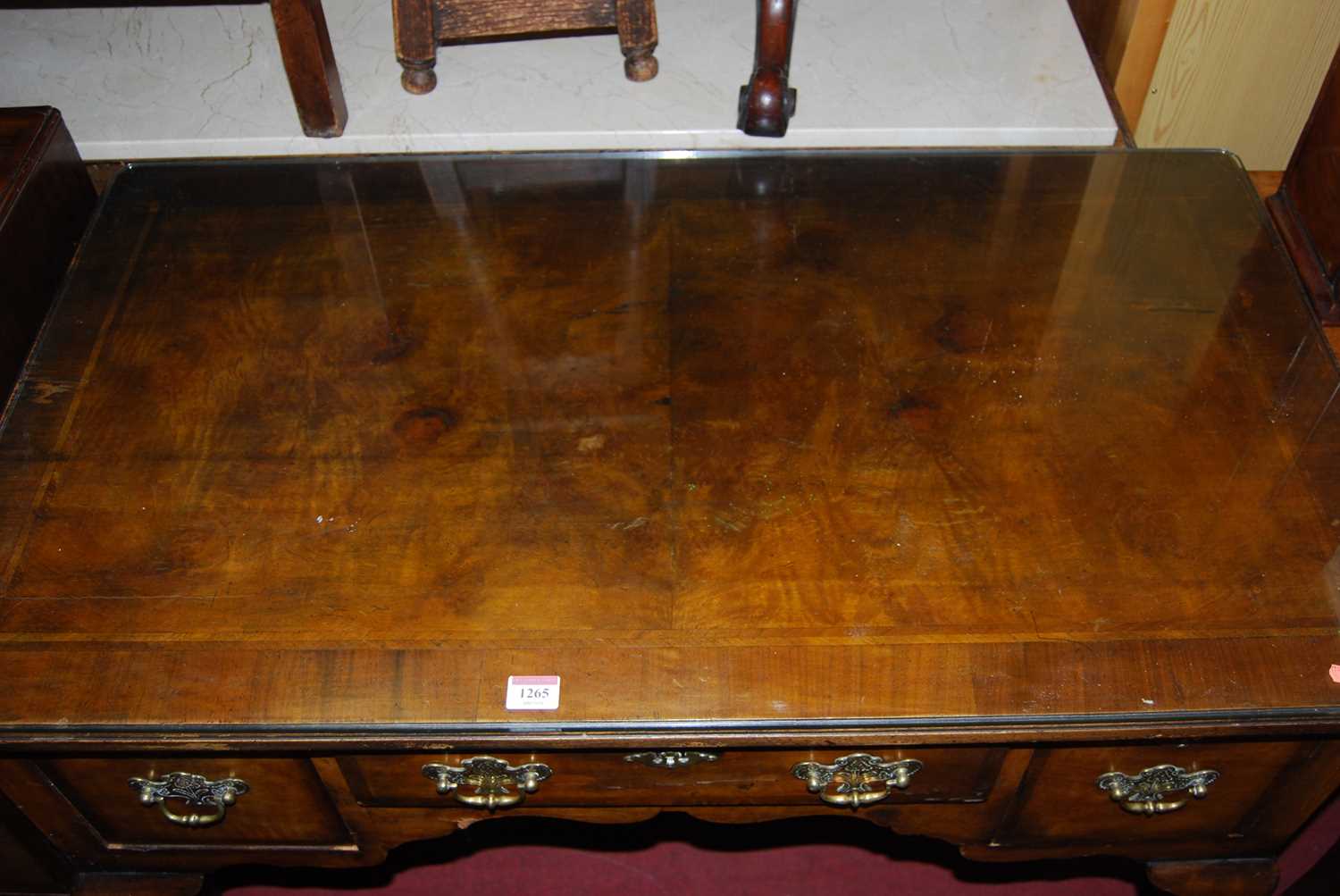 An early Georgian style figured walnut and feather banded three drawer kneehole lowboy, raised on - Image 5 of 5