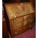 An early 19th century mahogany crossbanded and chequer strung slopefront three drawer writing