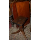 A Regency style mahogany D-end twin pillar dining table, having single extra leaf, reeded edge,