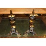 A pair of Edwardian brass and cast iron andirons, each with fleur de lys motifs