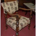 An early 20th century beech framed floral upholstered pad back and seat single elbow chair, width