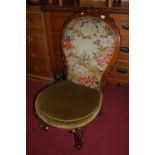 A mid-Victorian carved mahogany show frame and floral tapestry needlework upholstered parlour chair