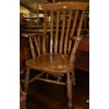 An elm seated lath back open armchairCondition report: Chair sits good and sound with a small amount