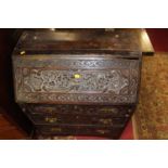 A Victorian carved oak bureau, decorated with flowers, w.76cm