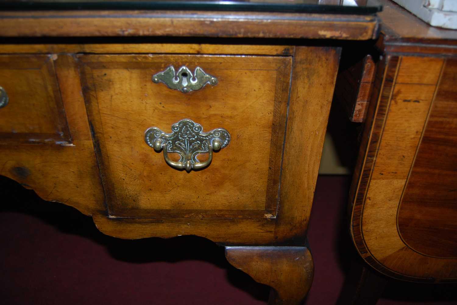 An early Georgian style figured walnut and feather banded three drawer kneehole lowboy, raised on - Image 3 of 5