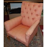 A 1920s child's upholstered armchair, raised on cabriole legs