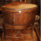 A 19th century mahogany corner washstand, having a single cupboard with drawer below on swept