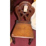 A Victorian mahogany hall chair, having a shaped back and solid seat on turned legs, together with a