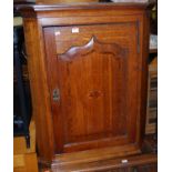 A 19th century provincial oak single door hanging corner cupboard