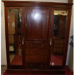An Edwardian mahogany and chequer strung gentleman's wardrobe, with twin long mirrored doors,
