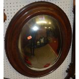 An early 20th century moulded oak framed and mirrored glass convex oval wall mirror, 58 x 45cm