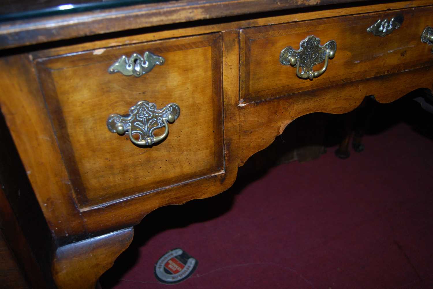 An early Georgian style figured walnut and feather banded three drawer kneehole lowboy, raised on - Image 2 of 5