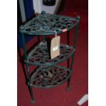 A green painted pierced and cast metal three tier corner stand
