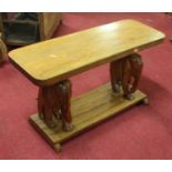 A 20th century carved hardwood coffee table, on elephant supports, 75 x 28cm